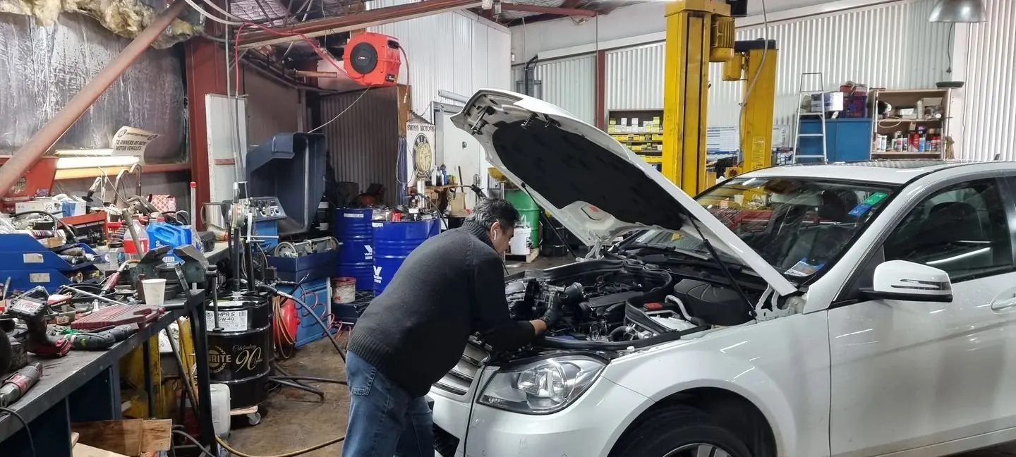 Mechanic working on a car at Swiss Motors in Mona Vale