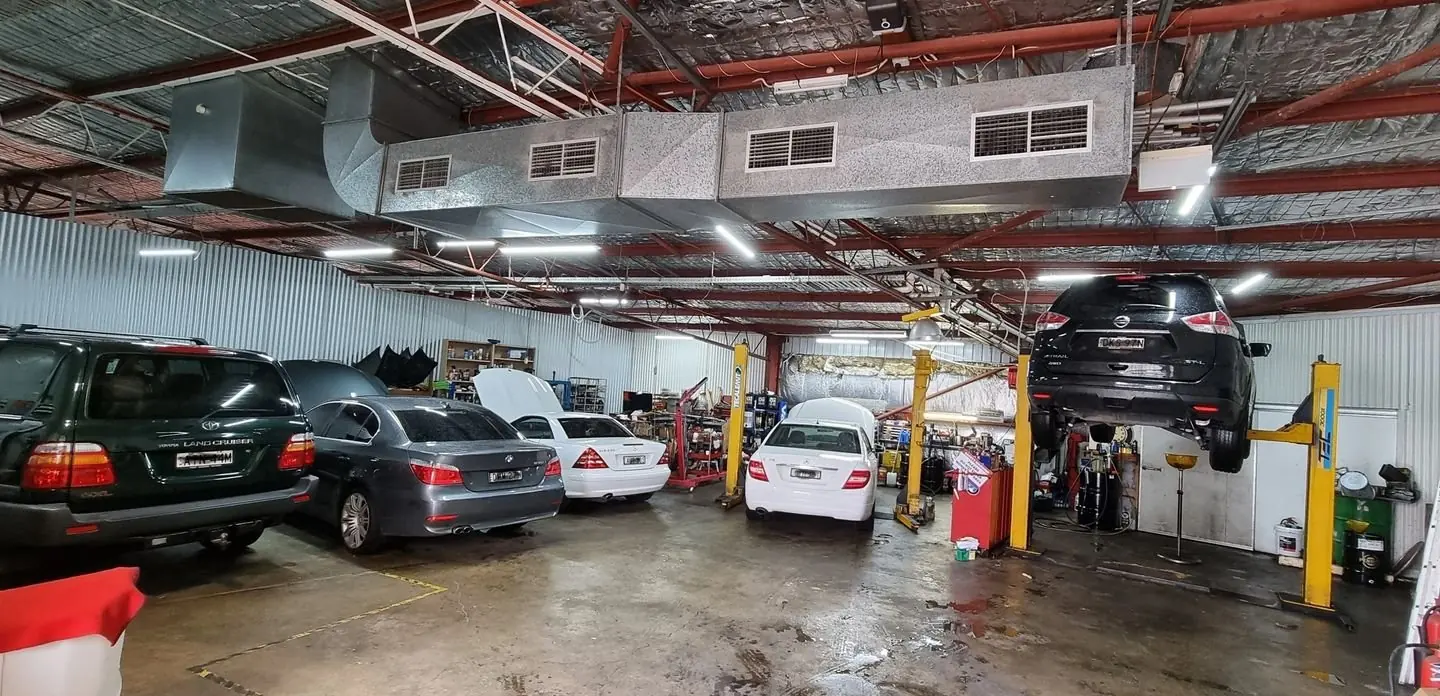 Vehicles and service bays inside the Swiss Motors workshop